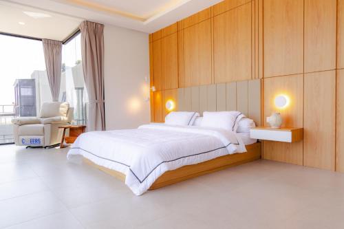 a bedroom with a large bed with a wooden wall at Manse 만세 Villa in Ciburial