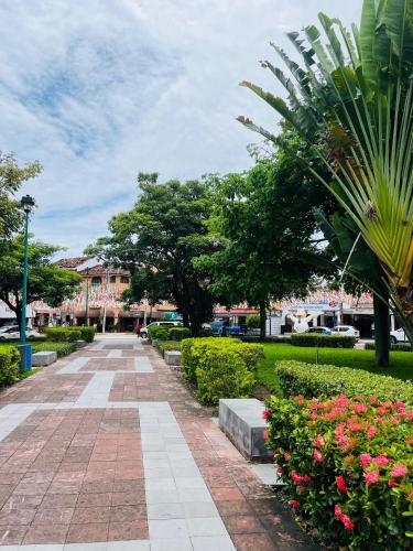 a walkway in a park with flowers and trees at Hotel Doña Mary Huatulco in Santa Cruz Huatulco