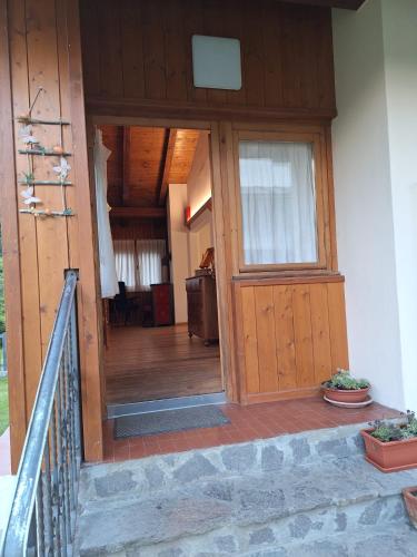 an entrance to a house with a wooden door at Chalet Luisa in Cima Gogna