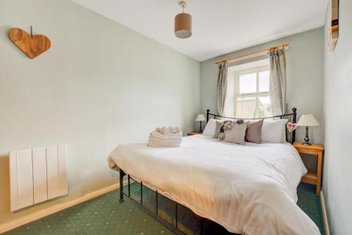 a bedroom with a large white bed with a window at 2 Bed in Leyburn oc-ds902 in Askrigg