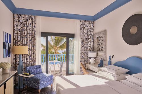 a hotel room with a bed and a chair at Seaside Los Jameos in Puerto del Carmen