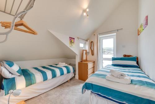 two beds in a room with a window at 2 Bed in Croyde oc-bolt in Croyde