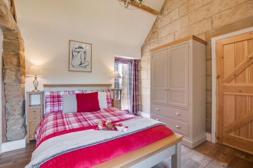 a bedroom with a large bed with a red blanket at 2 Bed in Saltburn-by-the-sea oc-wa021 in Easington