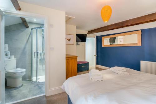 a bedroom with a white bed and a shower at 3 Bed in Askrigg oc-ds958 in Askrigg