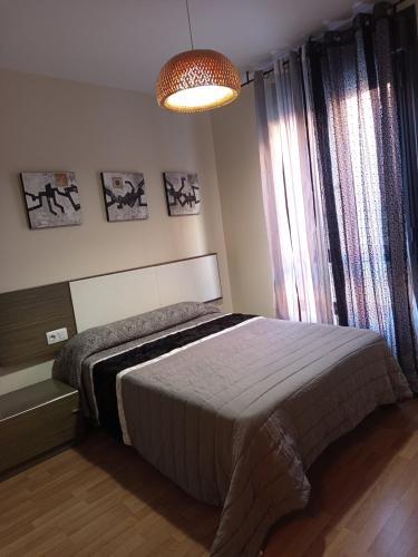 a bedroom with a bed and a large window at Apartamento en Navarrete in Navarrete