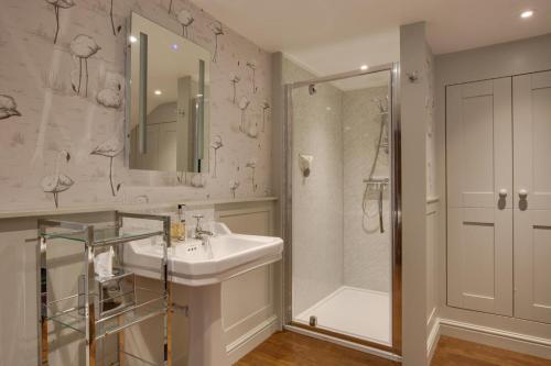 a white bathroom with a sink and a shower at 3 Bed in Sedbergh oc-ds960 in Milnthorpe