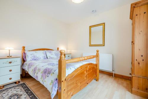 a bedroom with a bed and a dresser and a mirror at 1 Bed in Wadebridge oc-p00232 in Wadebridge