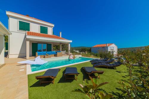 a villa with a swimming pool and a house at Villa Eni in Primošten