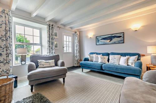 a living room with a blue couch and a chair at 2 Bed in Edmonton oc-p00586 in Wadebridge