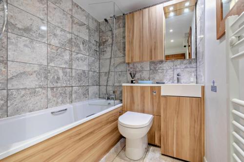 a bathroom with a toilet and a tub and a sink at 2 Bed in Edmonton oc-p00586 in Wadebridge
