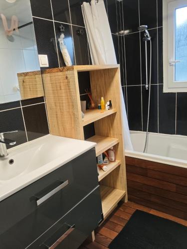 a bathroom with a sink and a shower and a tub at Maison 47m2 climatisé, piscine,linge fourni in Gujan-Mestras
