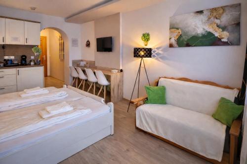 a living room with a bed and a couch at Mountain view apartments in Bad Mitterndorf