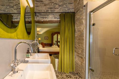 a bathroom with two sinks and a mirror and a bedroom at 5 Bed in Padstow oc-p00595 in Padstow