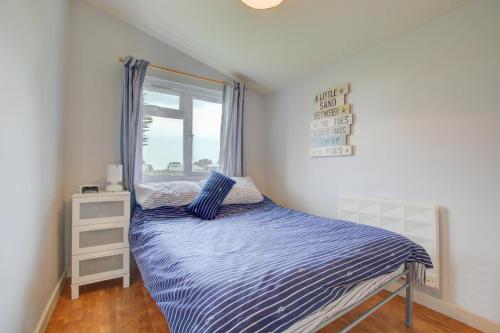 a bedroom with a bed and a window at 2 Bed in Padstow oc-p00551 in Saint Merryn