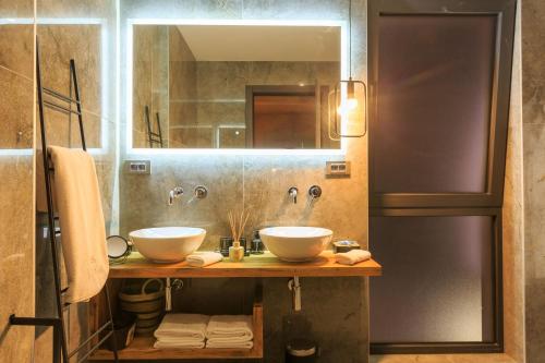 a bathroom with two sinks and a mirror at Villa Lorkia in Baška