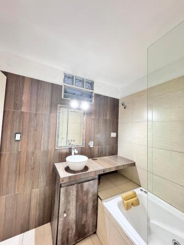 a bathroom with a sink and a bath tub at Casas Villa azul in Tanti