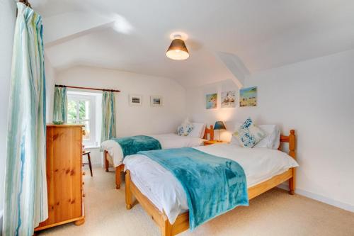 a bedroom with two beds and a window at 2 Bed in Bodmin oc-p00429 in Saint Teath