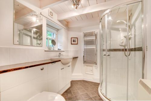 a white bathroom with a shower and a sink at 2 Bed in Bodmin oc-p00429 in Saint Teath