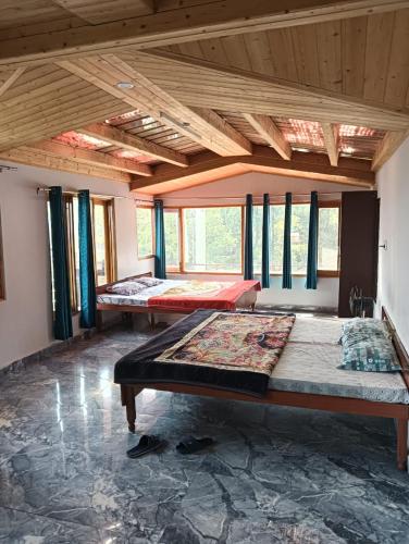 a room with three beds in it with windows at The Hostelers Homestay Shimla - Near ISBT, Bypass MC Parking and HPU in Shimla