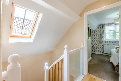 a white staircase with a window and a stair case at 2 Bed in Sledmere oc-ey103 in Sledmere