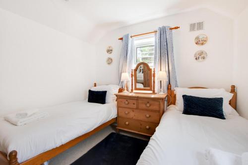 two twin beds in a room with a mirror at 2 Bed in Sandsend oc-wa317 in Sandsend