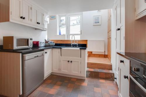 a kitchen with white cabinets and a sink at 2 Bed in Sandsend oc-wa317 in Sandsend