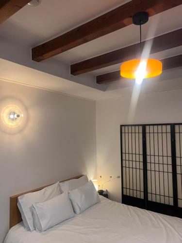 a bedroom with a bed with a light on the ceiling at Stay Us 3151 in Seongnam