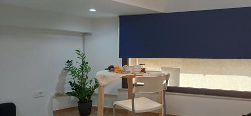 a kitchen with a table and a blue wall at Casa XX Settembre Deluxe in Misterbianco