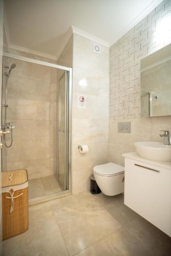 a bathroom with a shower and a toilet and a sink at Riverside Life Residence in Trikomo