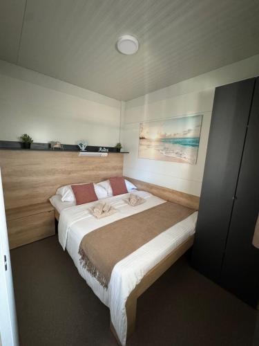 a bedroom with a large bed in a room at Mobile Home Clelia in Sveti Petar