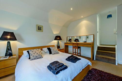 a bedroom with a bed with two towels on it at 4 Bed in Tenby oc-t27576 in Tenby