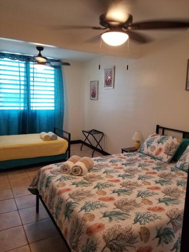 a bedroom with a bed with towels on it at Beach vibes condo in Luquillo in Luquillo