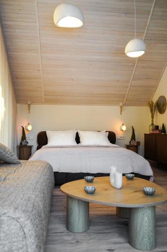 a bedroom with a bed and a coffee table at Апартаменти Rest Hill in Vorokhta