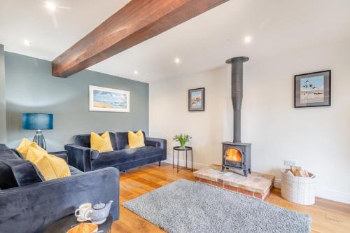 a living room with a couch and a fireplace at 3 Bed in Little Snoring oc-m28145 in Little Snoring