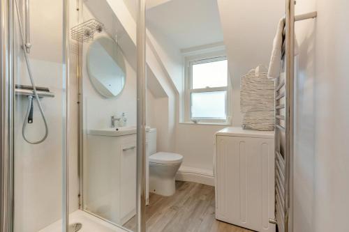 a bathroom with a toilet and a sink and a shower at 2 Bed in Swanage oc-wy527 in Swanage