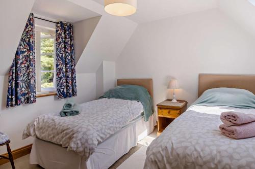 a bedroom with two beds and a window at 2 Bed in Lindsey oc-w28111 in Monks Eleigh