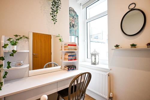 a dressing room with a mirror and a desk at Enbrook View in Sandgate