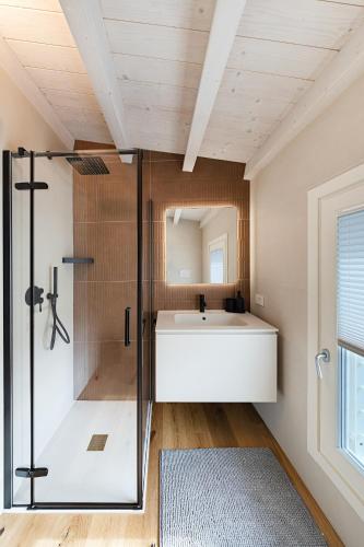 a bathroom with a shower and a tub and a sink at Luxury Villa Prestige in Sirmione