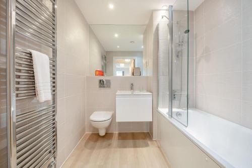 a white bathroom with a toilet and a shower at 2 Bed in Bournemouth oc-b27914 in Bournemouth
