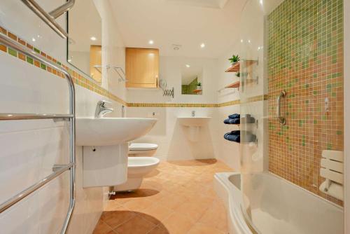 a bathroom with a sink and a toilet and a shower at 9 Bed in St. Agnes oc-port20 in St. Agnes