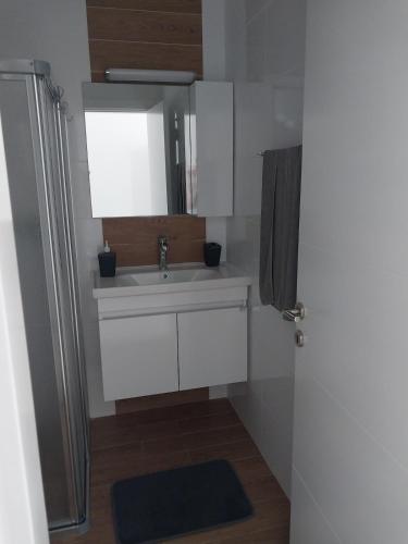 a bathroom with a sink and a mirror at Pool View Apartment with Hotel Facilities in Iskele