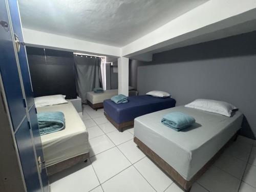 a room with two beds in a room at THE BROTHERS in Angra dos Reis