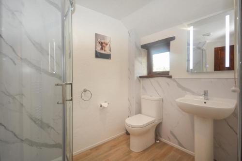a bathroom with a toilet and a sink and a shower at 2 Bed in St. Merryn oc-w29716 in Saint Merryn