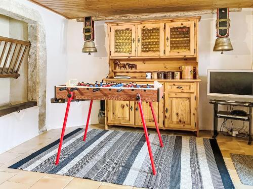 a table with red legs in a room at Apartment Les Grangettes by Interhome in Auberson