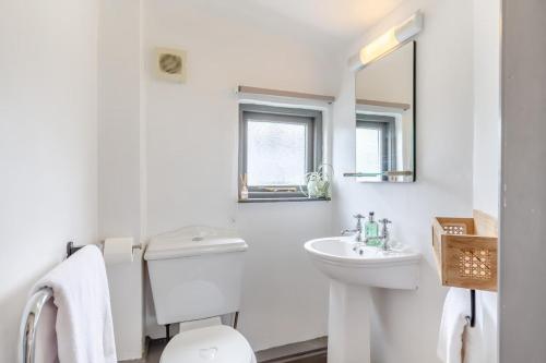 a white bathroom with a sink and a toilet at 1 Bed in Morwenstow oc-t29298 in Morwenstow