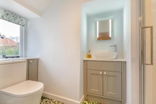 a bathroom with a sink and a toilet and a mirror at 1 Bed in Wells oc-h30450 in Wells