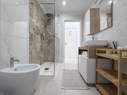 a bathroom with a tub and a sink and a shower at B&B Sabò in Bologna