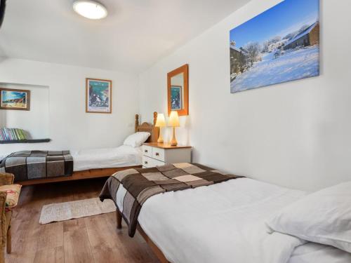 a bedroom with two beds and a mirror at 4 Bed in Hebron oc-y30097 in Whitland