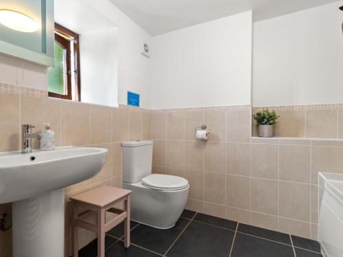 a bathroom with a white toilet and a sink at 4 Bed in Hebron oc-y30097 in Whitland