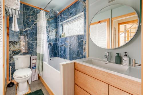 a bathroom with a toilet and a sink and a mirror at Modern Cabin near Watkins Glen in Alpine